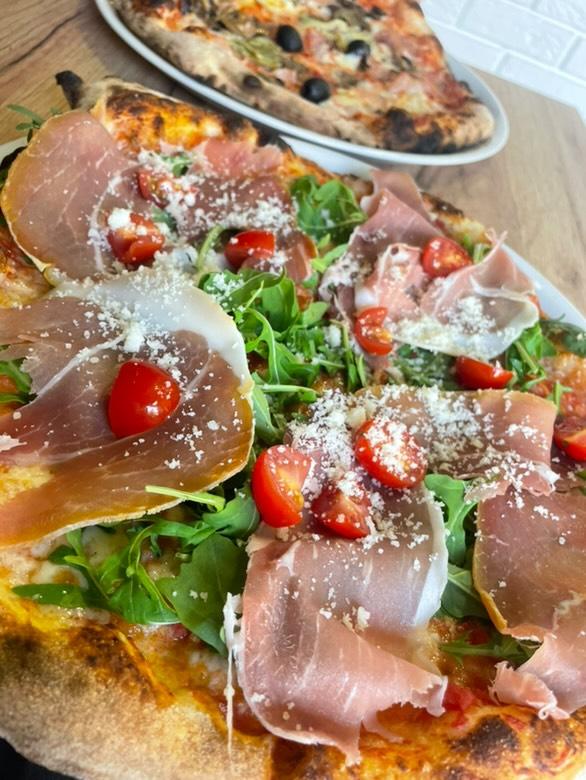 Pizza z prosciutto, rukolą i pomidorkami